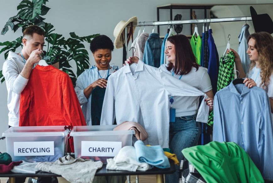 4 people looking through clothing